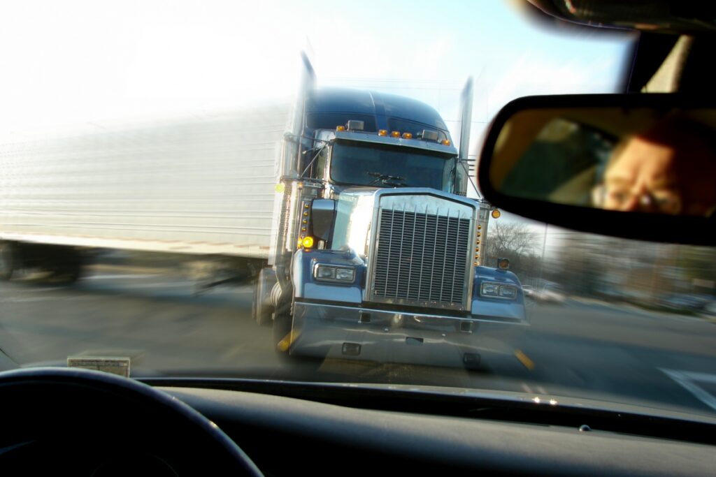 semi truck about to hit a passenger car, get help from the Law Offices of Kenneth G. Egan