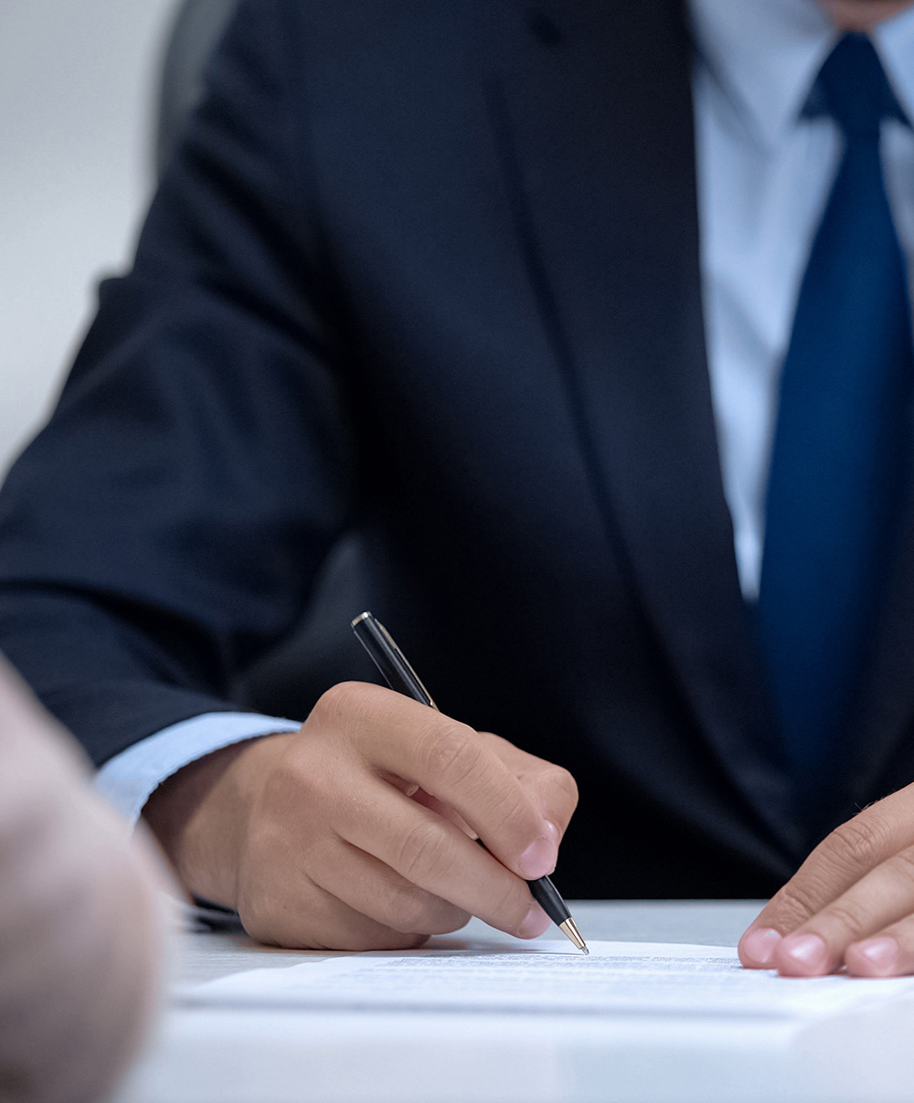 Man in business suit signing contract