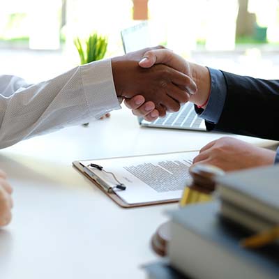 Lawyer shaking hands with a client.