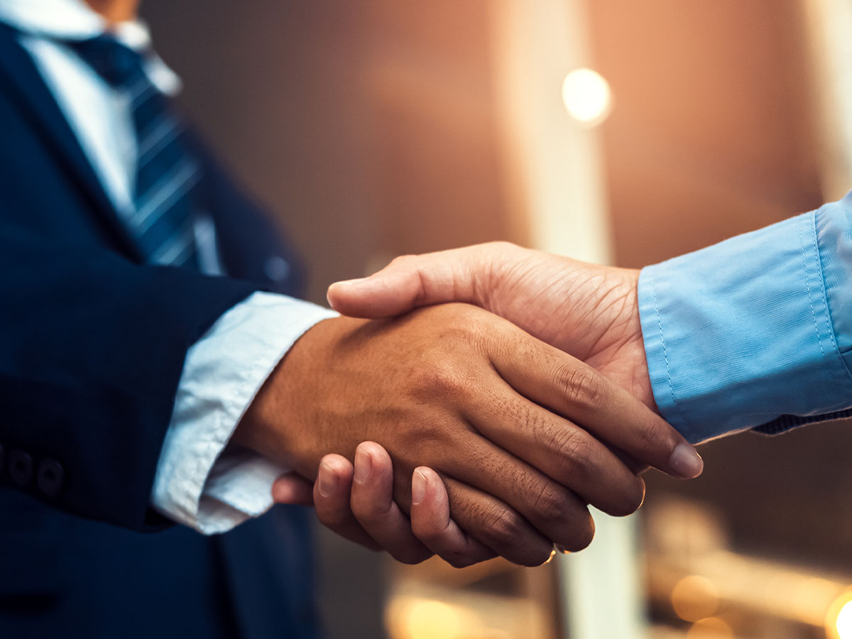 Closeup of two men’s shaking hands