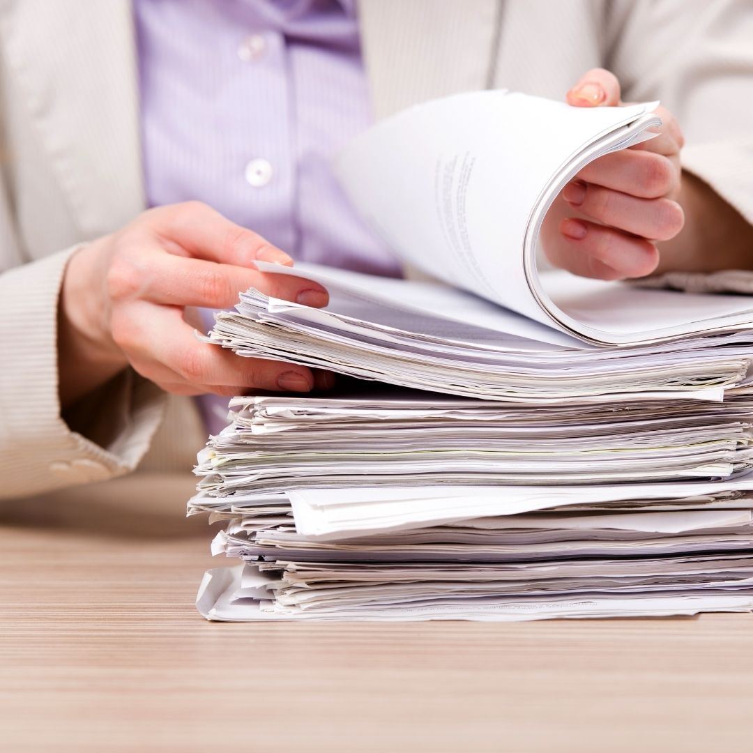 person flipping through a stack of papers